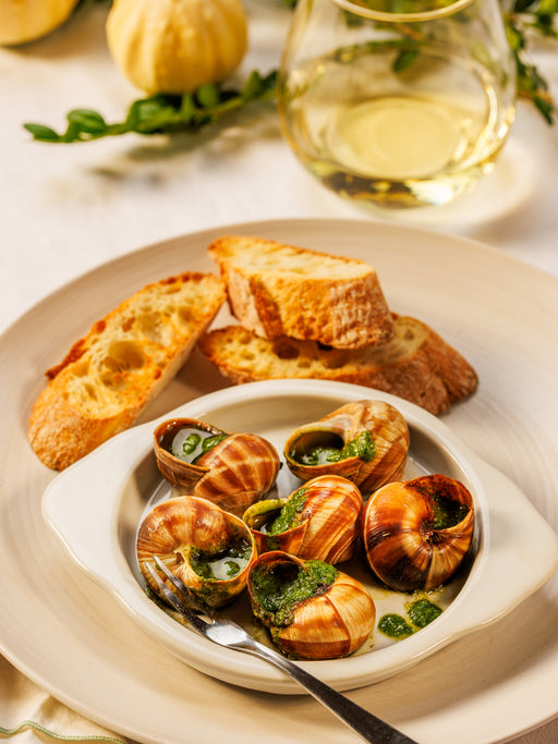 Fresh escargot snails from Browne Trading Company displayed in a natural setting for gourmet cooking.
