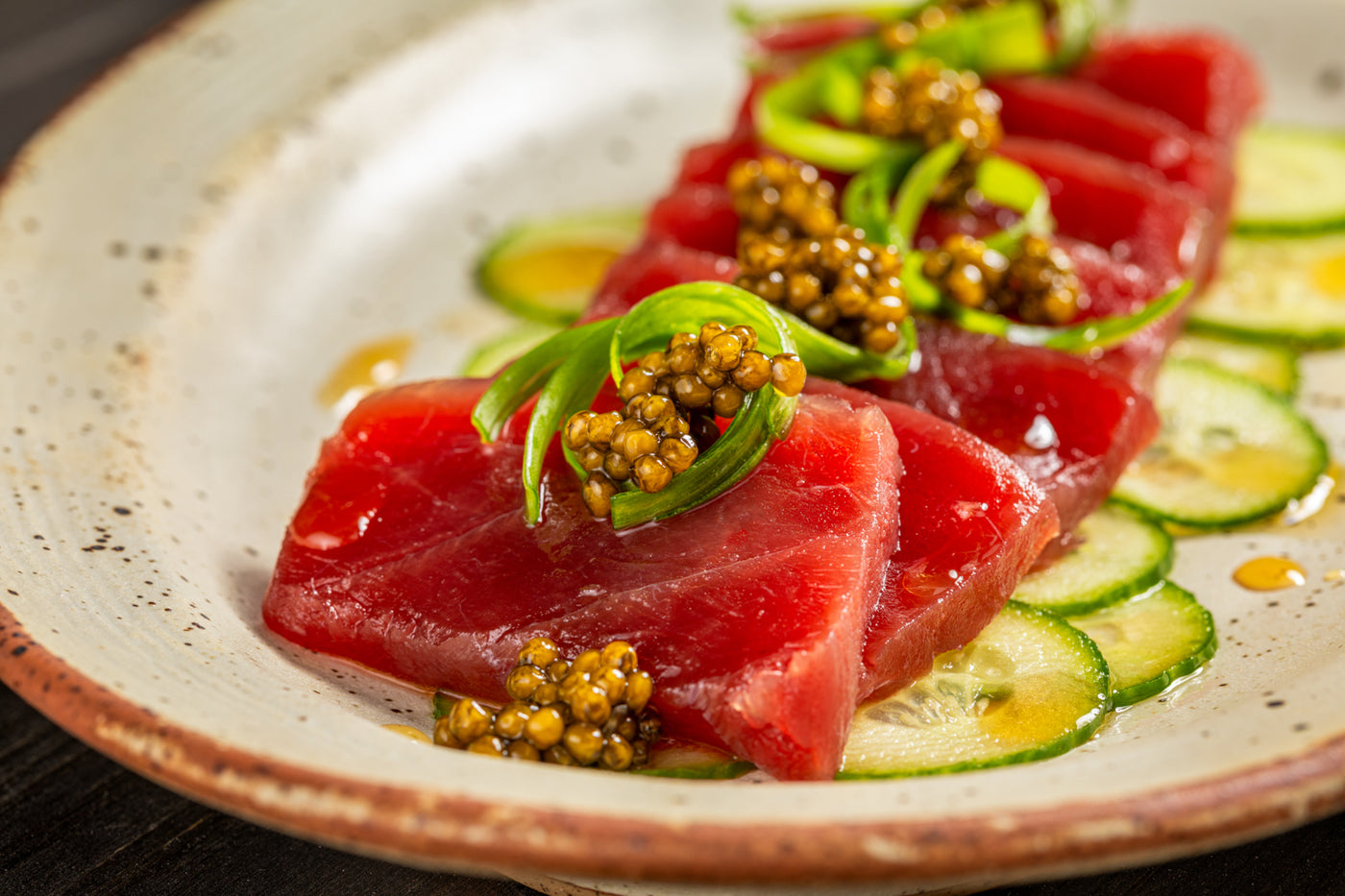 Bluefin tuna with Imperial Schrenckii Amur caviar, featuring shiny black roe on fresh tuna fillet, from Browne Trading Company.