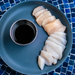 Fresh Maine Dayboat Scallops from Browne Trading Company, showcasing plump, white and blush-colored scallops ready for cooking.