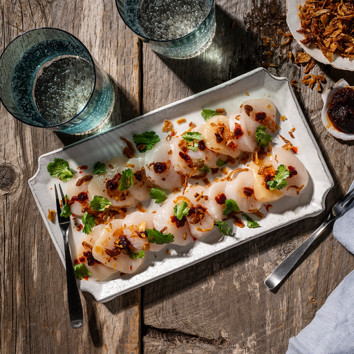 Fresh Maine dayboat scallops from Browne Trading Company, displayed as raw scallops suitable for crudo or seafood dishes.