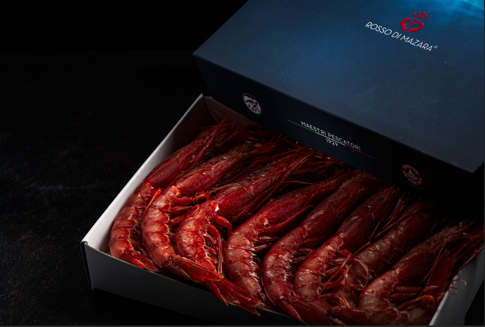 Fresh Gambero Rosso prawns from Browne Trading Company, displayed in a clear container on a bed of ice.