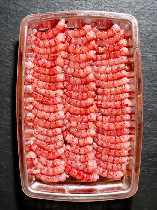Fresh Gambero Rosso prawns from Browne Trading Company, showcasing vibrant, cooked seafood with shells and tails intact.