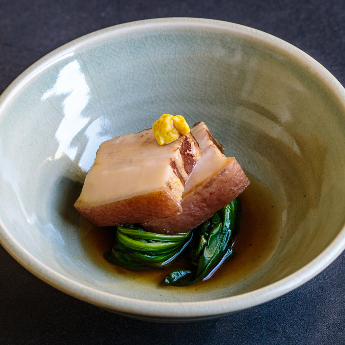 Crushed Okinawan brown sugar by Muruakami, shown in a rustic presentation with chunks and fine grains for baking and sweetening.