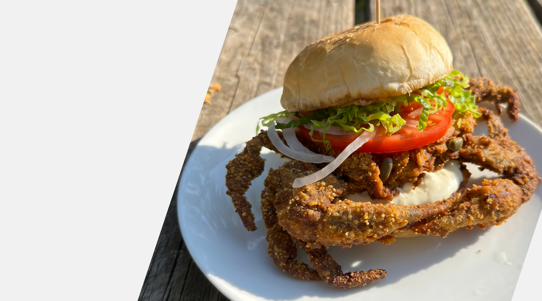 Burger with fried crab on a white plate on a wooden surface