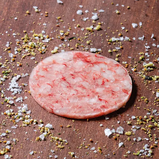Thin slices of Gambero Rosso prawn carpaccio from Browne Trading Company, arranged on a plate with garnish.