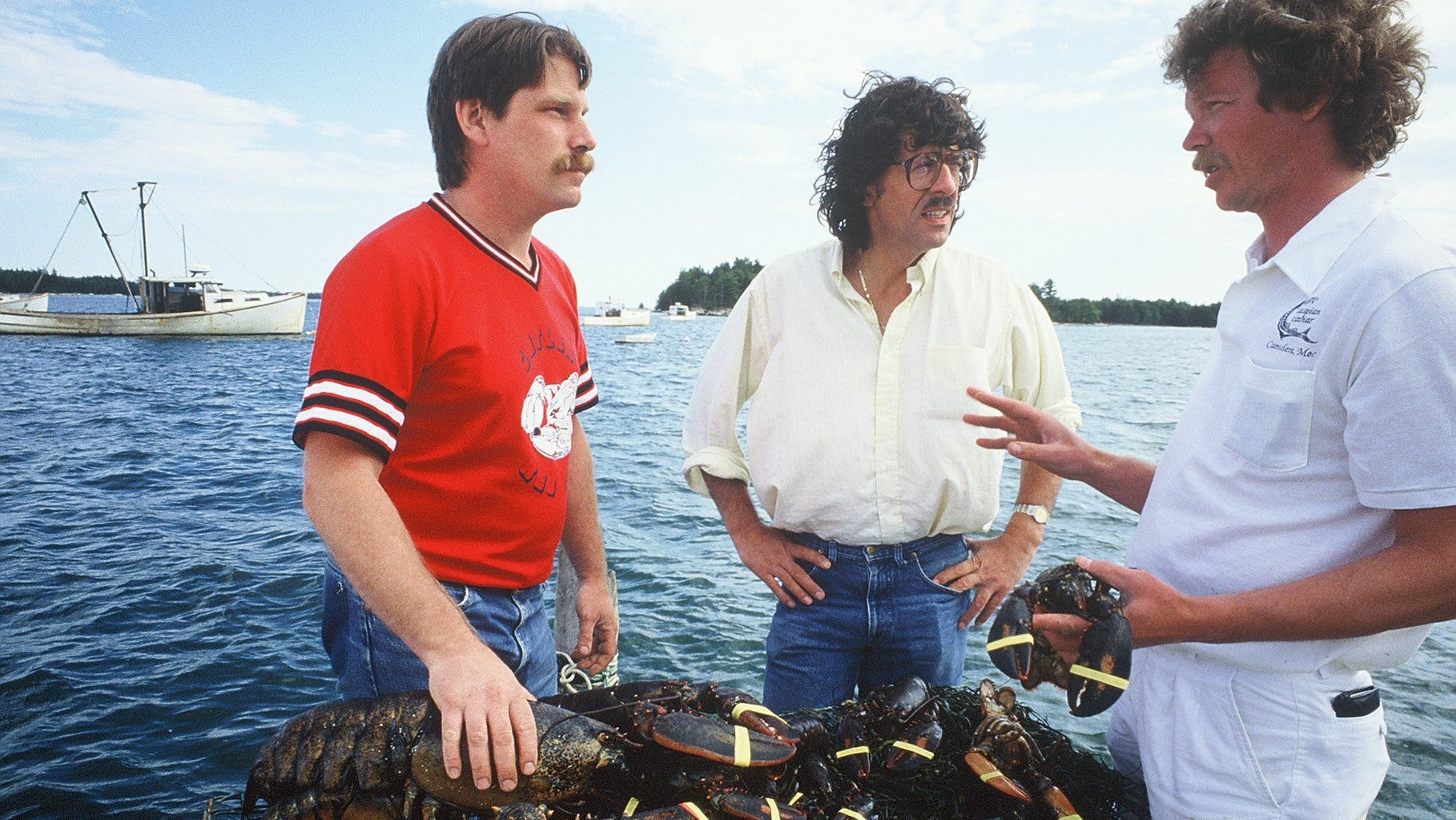 Rod, Jean Louis Palladin, and a lobsterman holding lobster together on a dock