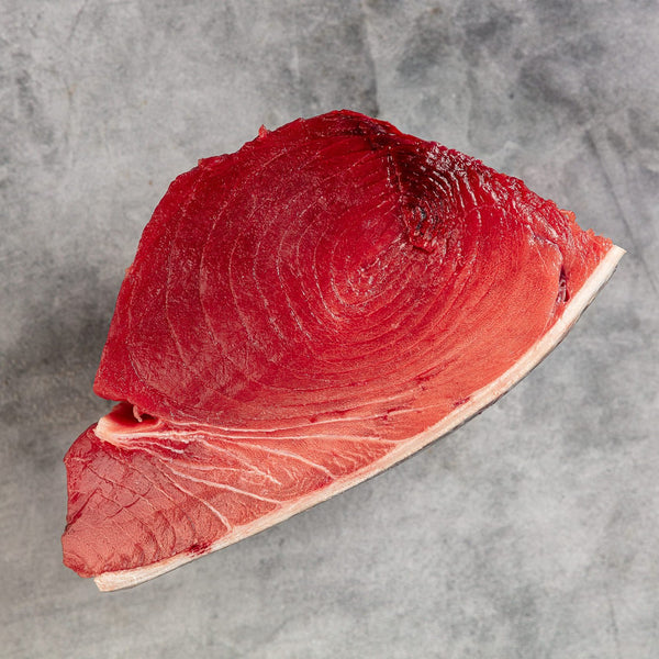Maine Bluefin Tuna Loin from Browne Trading Company, sliced side view showing rich, deep red fish meat with marbling.