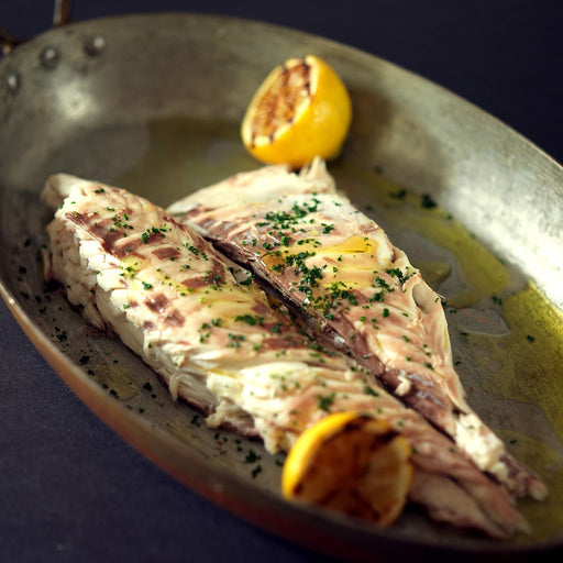 Fresh Daurade Sea Bream from Browne Trading Company, whole fish with silver skin and fins, ready for cooking or grilling.